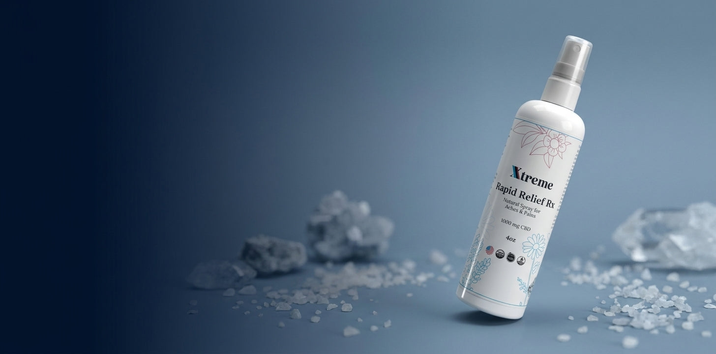 Xtreme Rapid Relief Rx topical magnesium CBD spray bottle with 1000 mg CBD on a slate blue background surrounded by mineral salt crystals