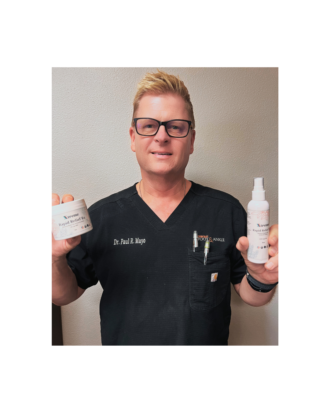 Dr. Paul Mayo holding Xtreme Brands RX Rapid Relief Spray and RX Rapid Relief Balm – doctor-endorsed hemp-derived CBD formulas with Arnica, Turmeric, and Menthol for targeted muscle and joint relief.