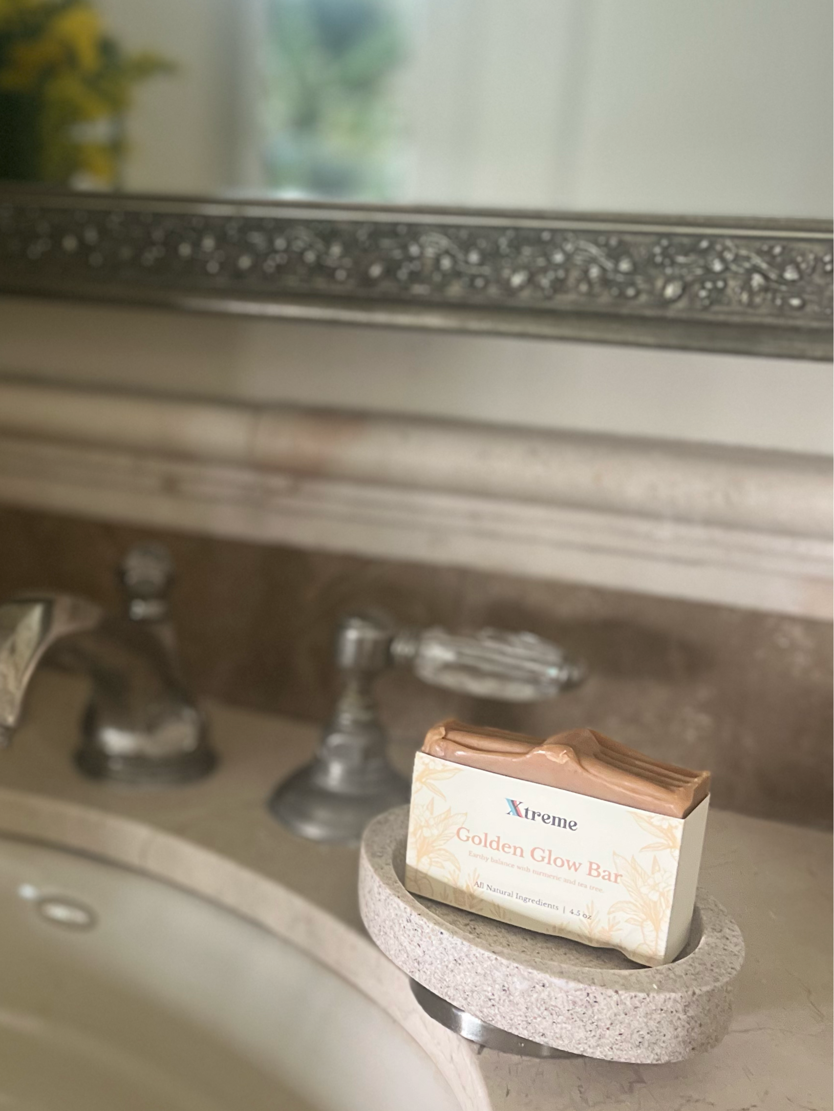Golden Glow handmade soap on bathroom sink – USA-made artisan bar with turmeric and citrus for brightening and refreshing skin.
