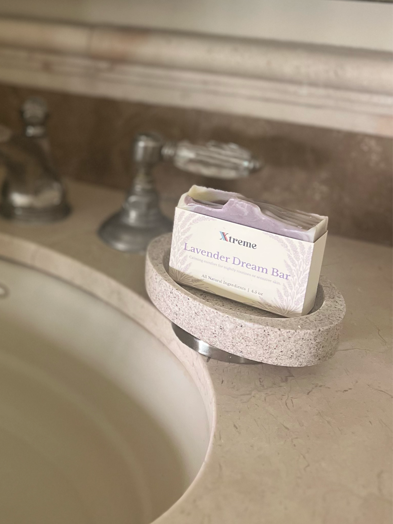 Lavender Dream handmade soap bar on bathroom sink – USA-made artisan bar with lavender for a calming and soothing cleanse.
