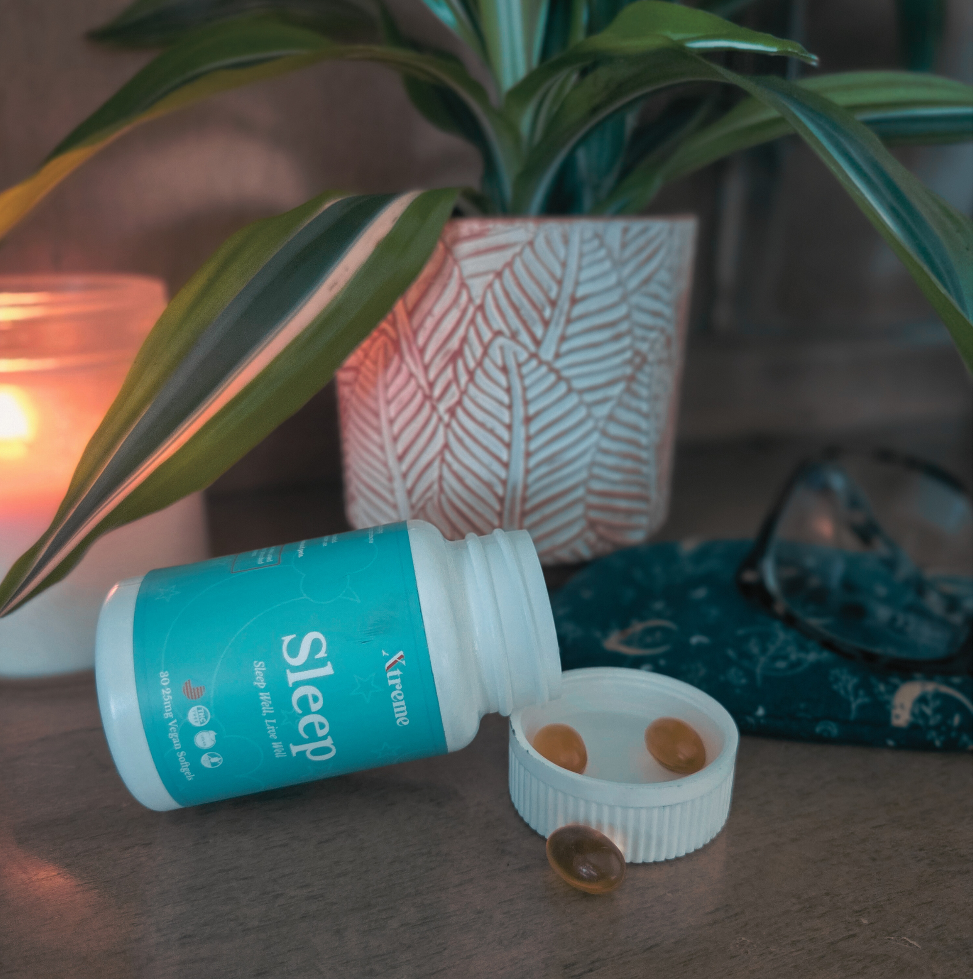 Xtreme Brands Sleep Softgels with capsules laid out beside a candle and sleep mask – USA-made natural supplement with full-spectrum hemp and melatonin for deep, restorative rest.