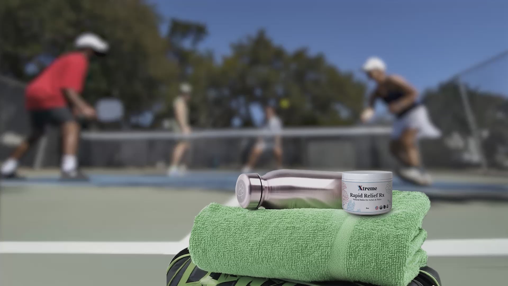 Load video: Xtreme RX Rapid Relief Balm shown courtside while adults play pickleball—USA-made, doctor-trusted natural pain relief for active movement.