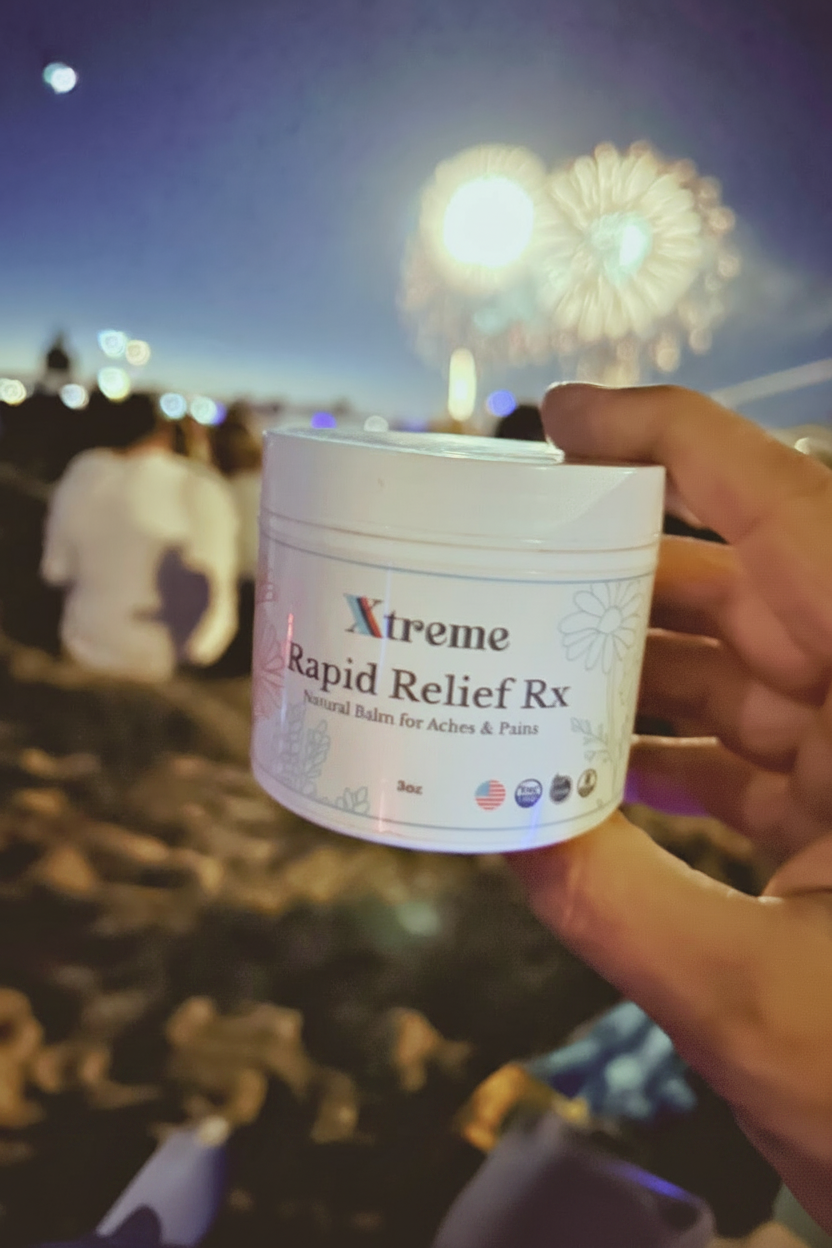 Xtreme Brands RX Rapid Relief Balm held with fireworks in the background – strongest doctor-trusted formula with full-spectrum hemp, Arnica, and Menthol for targeted pain relief.
