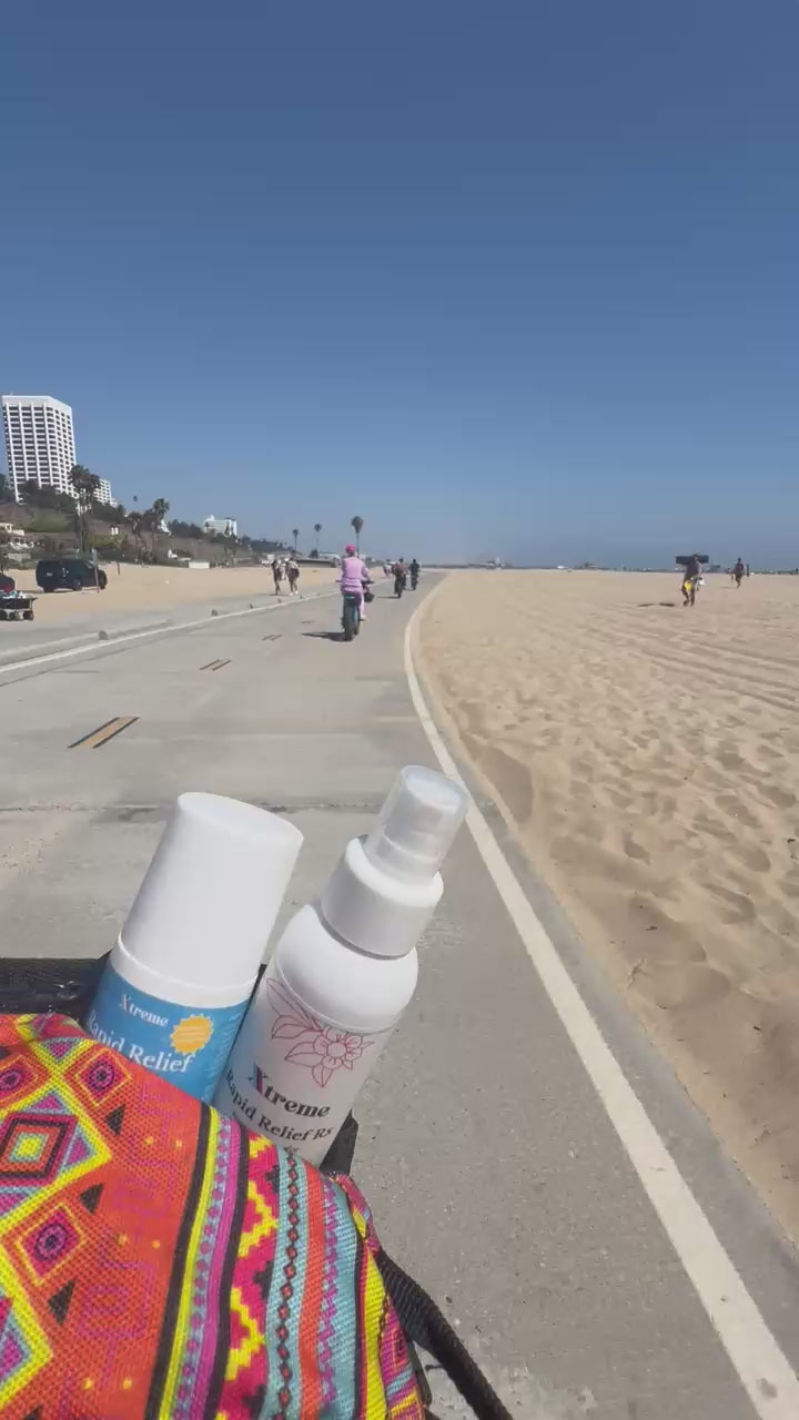 Xtreme Rapid Relief Roll-On on a moped at the beach – USA-made natural pain relief with full-spectrum hemp, Arnica, and Menthol.

