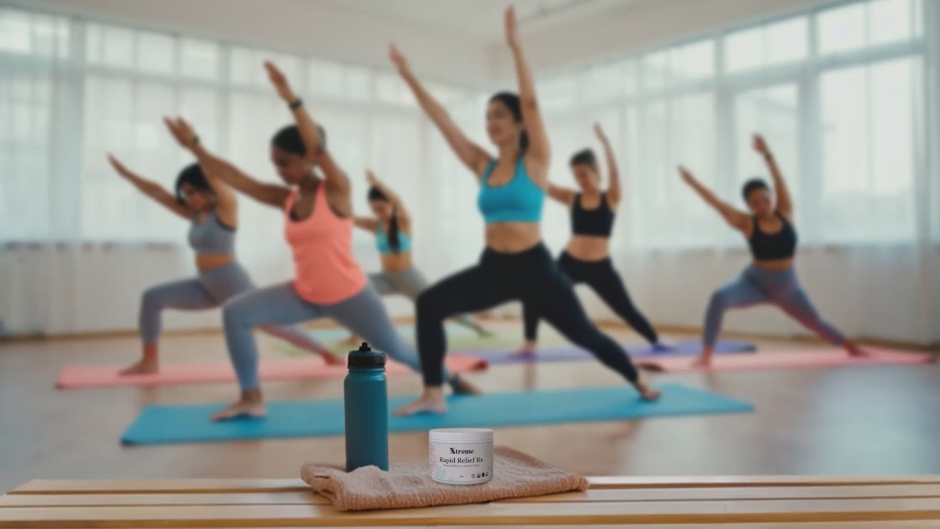 Xtreme Brands RX Rapid Relief Balm in focus with people doing yoga in the background – strongest doctor-trusted formula with full-spectrum hemp, Arnica, and Menthol for targeted pain relief.
